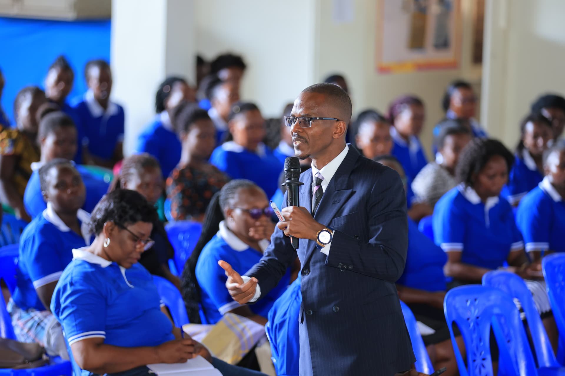 Newton Buteraba addressing students in a school hall