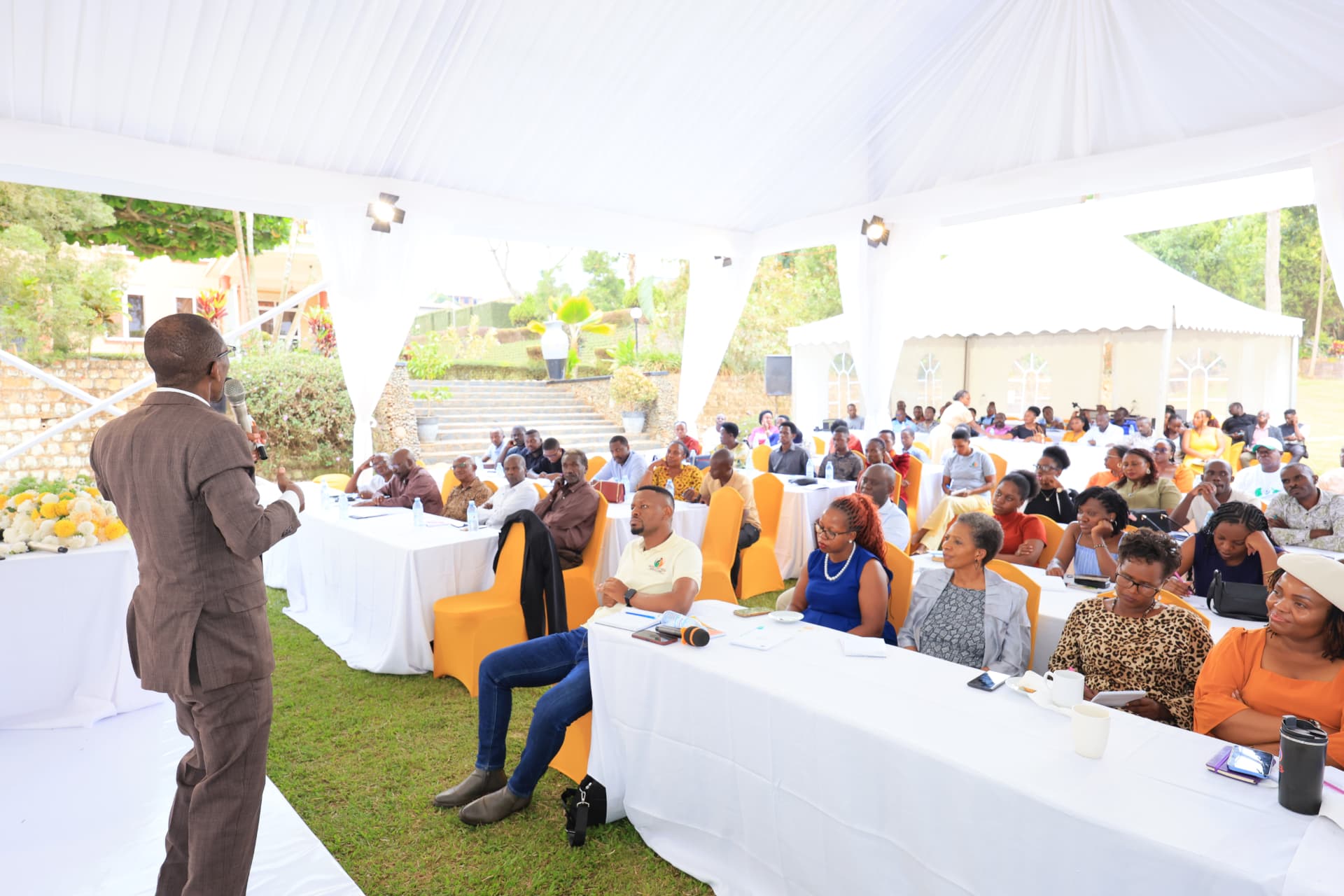 A full marquee audience listening to Newton Buteraba